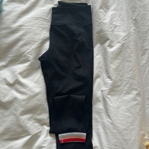 Splits59 black leggings with pockets and red, pink, white striped band. Size M